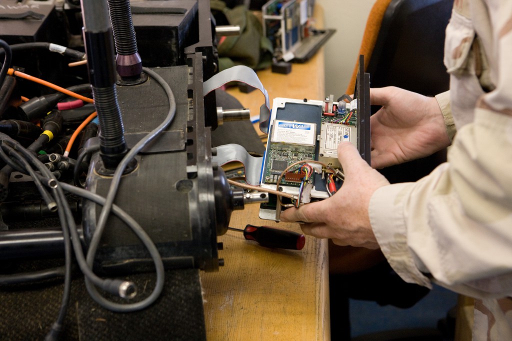 Technician Working on Foster-Miller Robot&#39;s RF Module