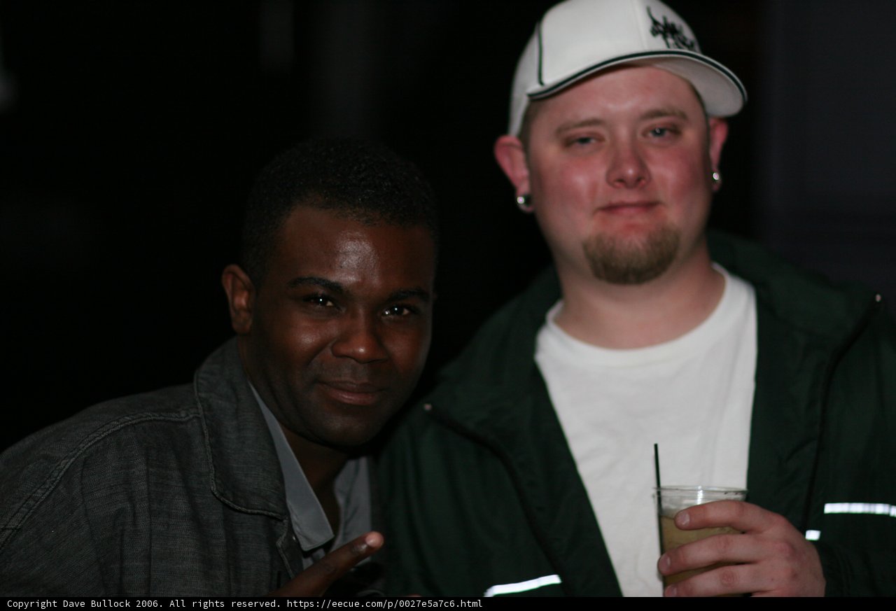 Two men enjoying drinks at the Bass Rush 4 Year celebration
