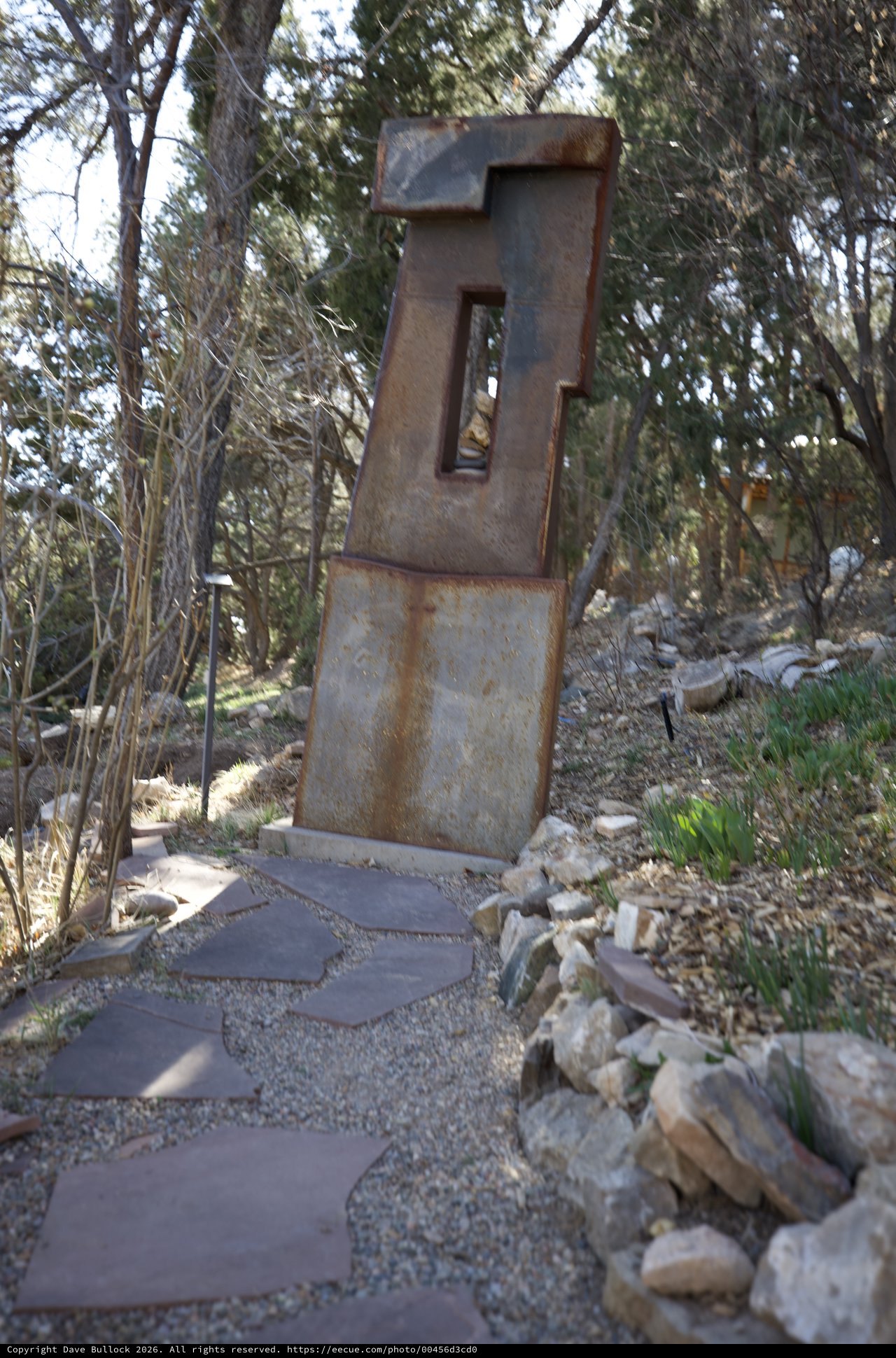 Rusted Metal Sculpture in Wooded Garden Setting