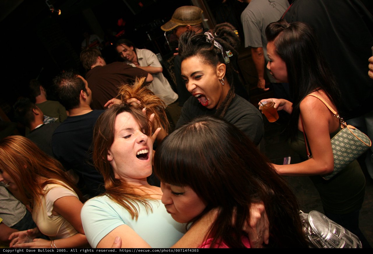 Friends Dancing and Laughing at Nightclub Party