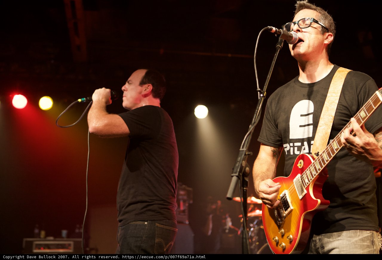 Two Men Rocking the Stage with their Guitars
