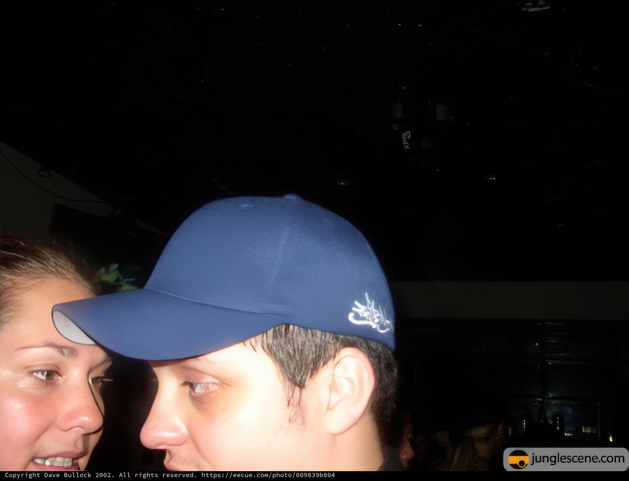 Hat-Topped Couple Locked in Gaze