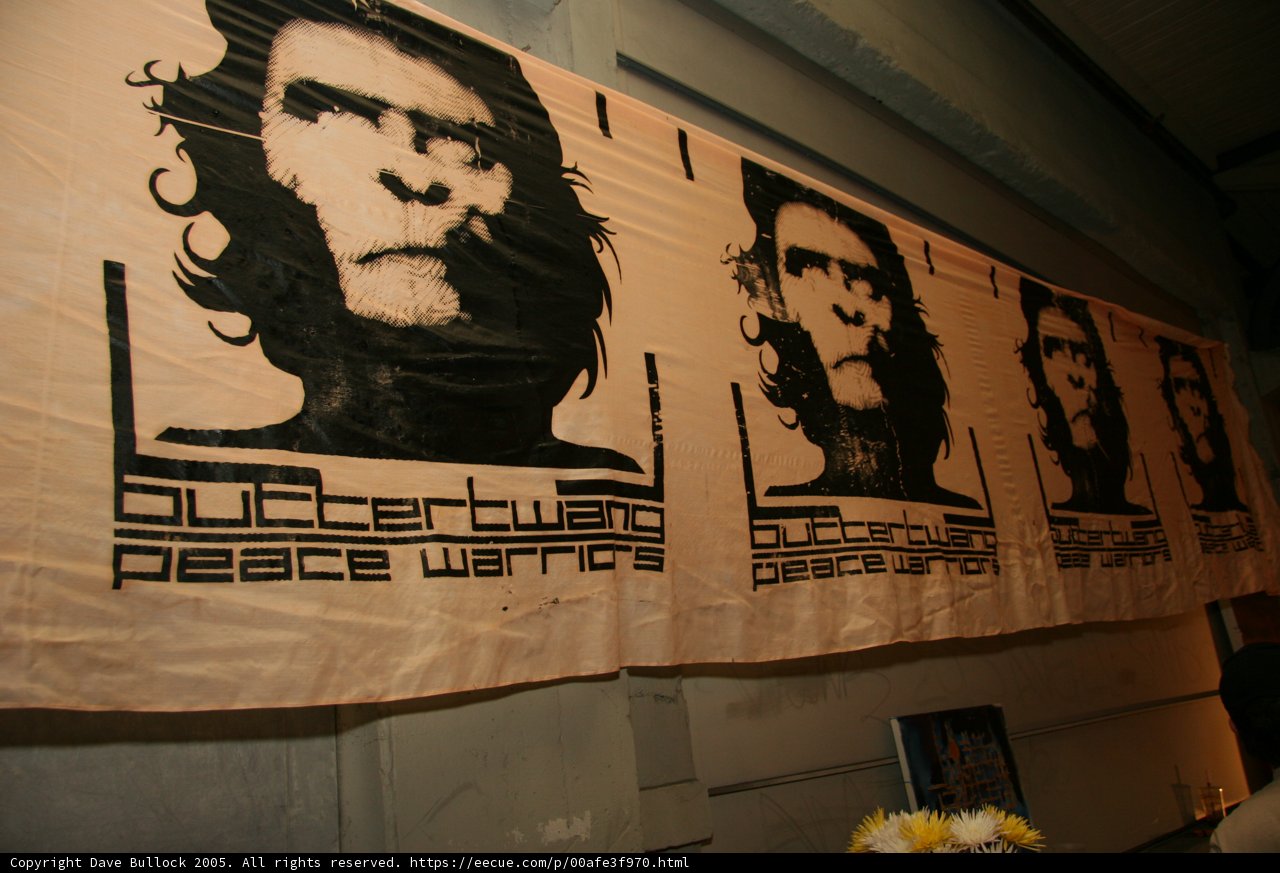 Four Ape Faces on a Banner