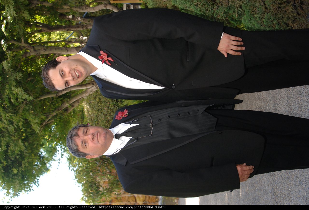 Father and Son Pose Together at Wedding Celebration