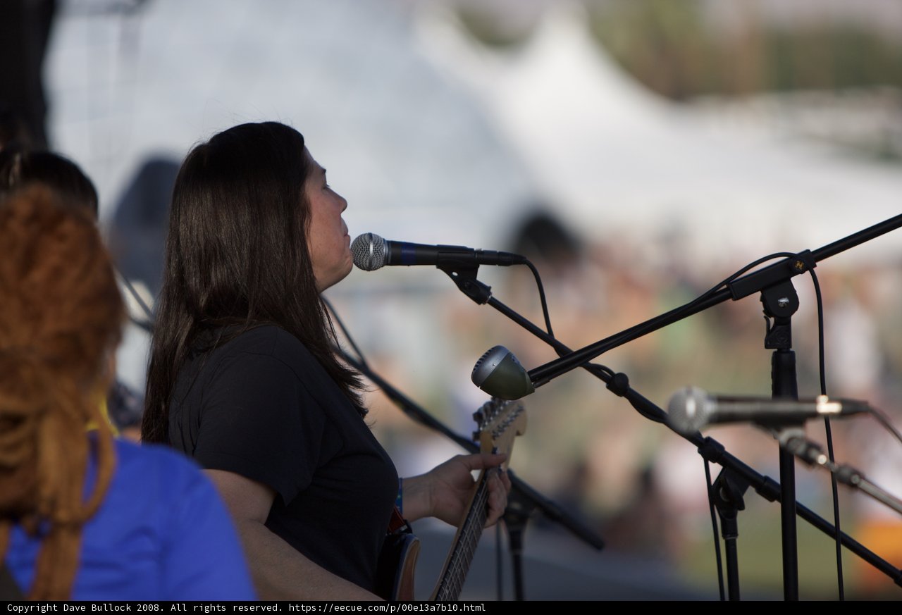 Rocking the Stage Caption: A female entertainer sings her heart out into two microphones to a cheering crowd during her performance at Coachella 2008.