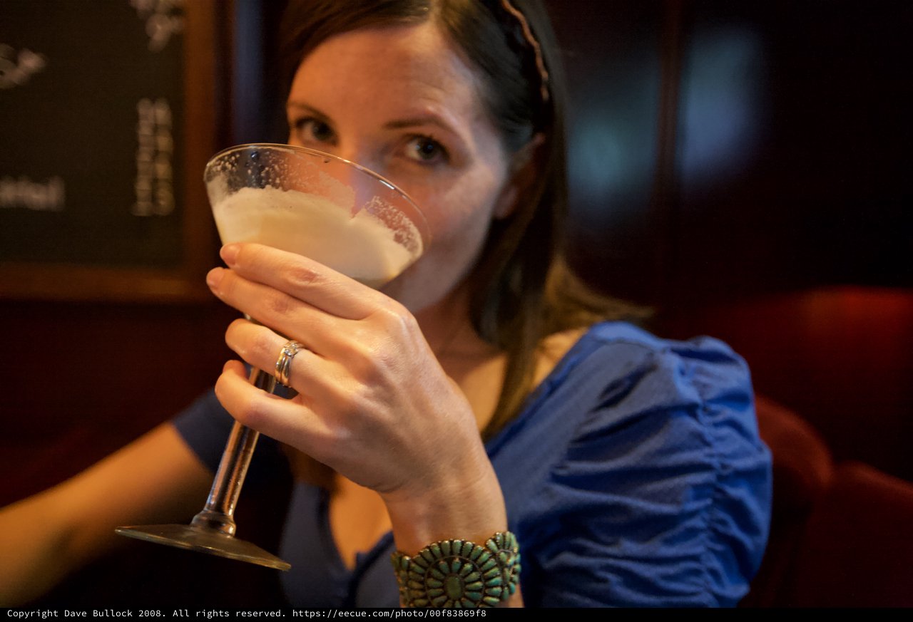Woman Sipping Cocktail at Upscale Bar