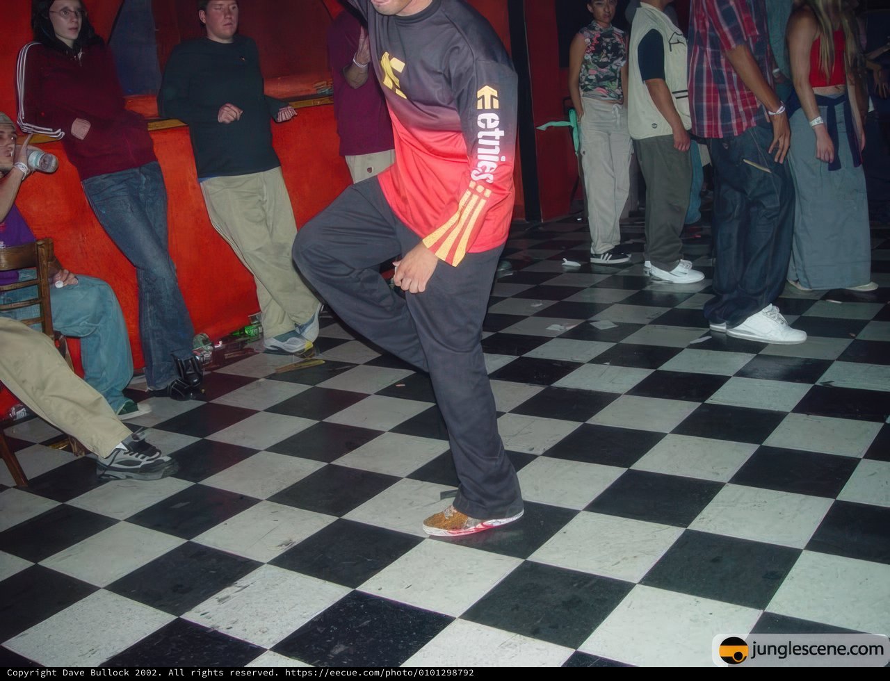 Red-shirted man getting his groove on at a nightclub