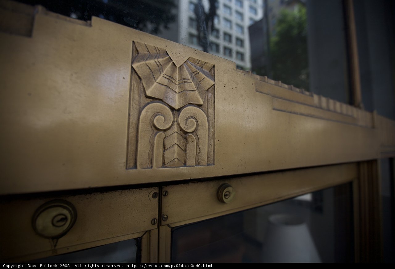 The Intricate Wooden Emblem on the Golden Monastery Door
