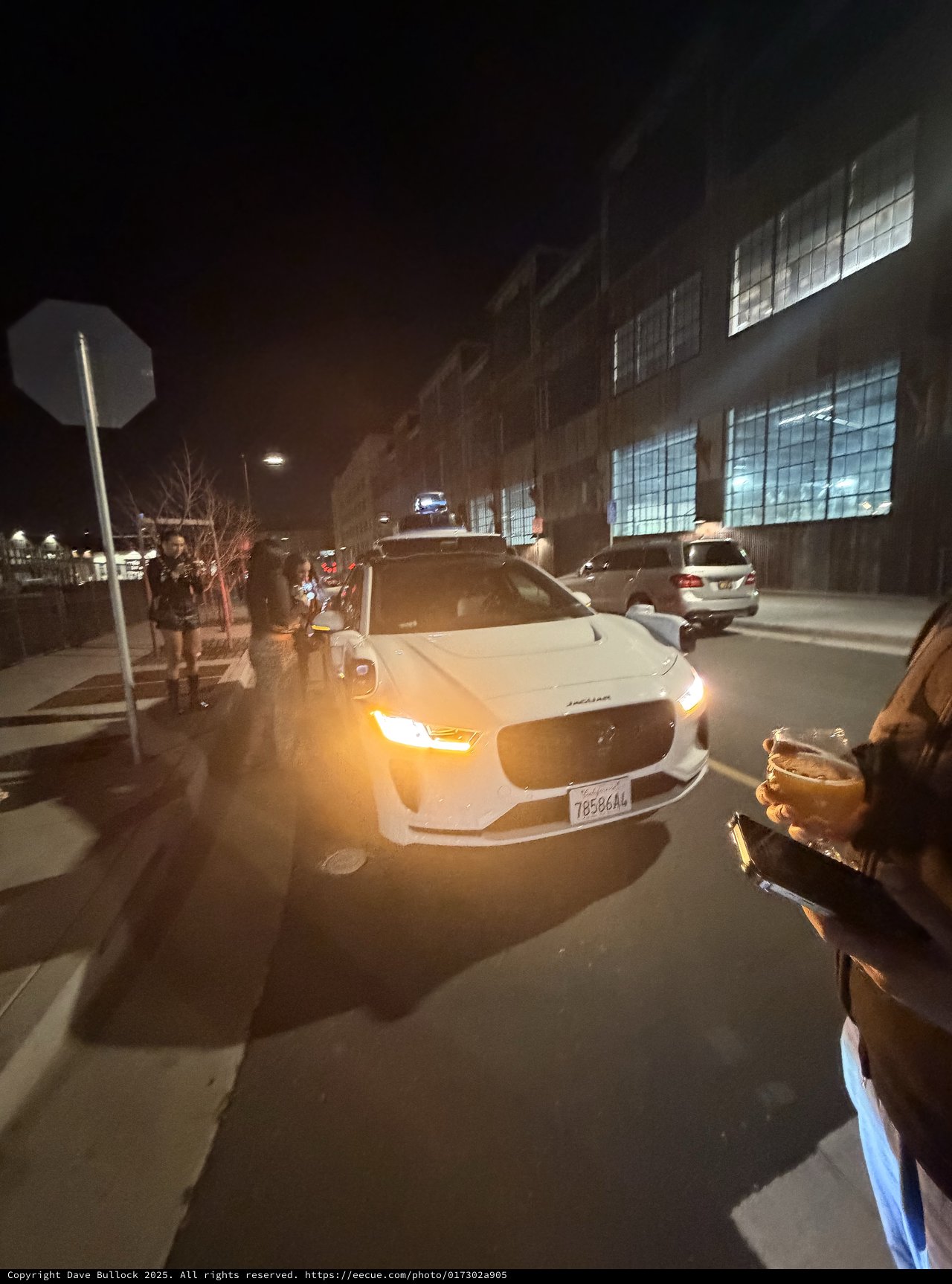 White Sedan on Urban Street at Night