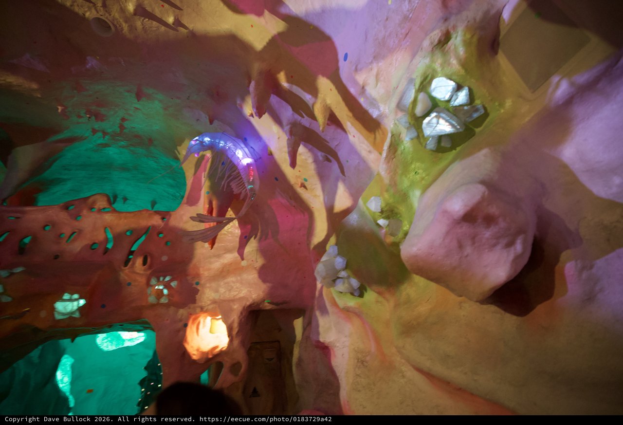 Illuminated Fantasy Cave Interior with Colorful Sculptures