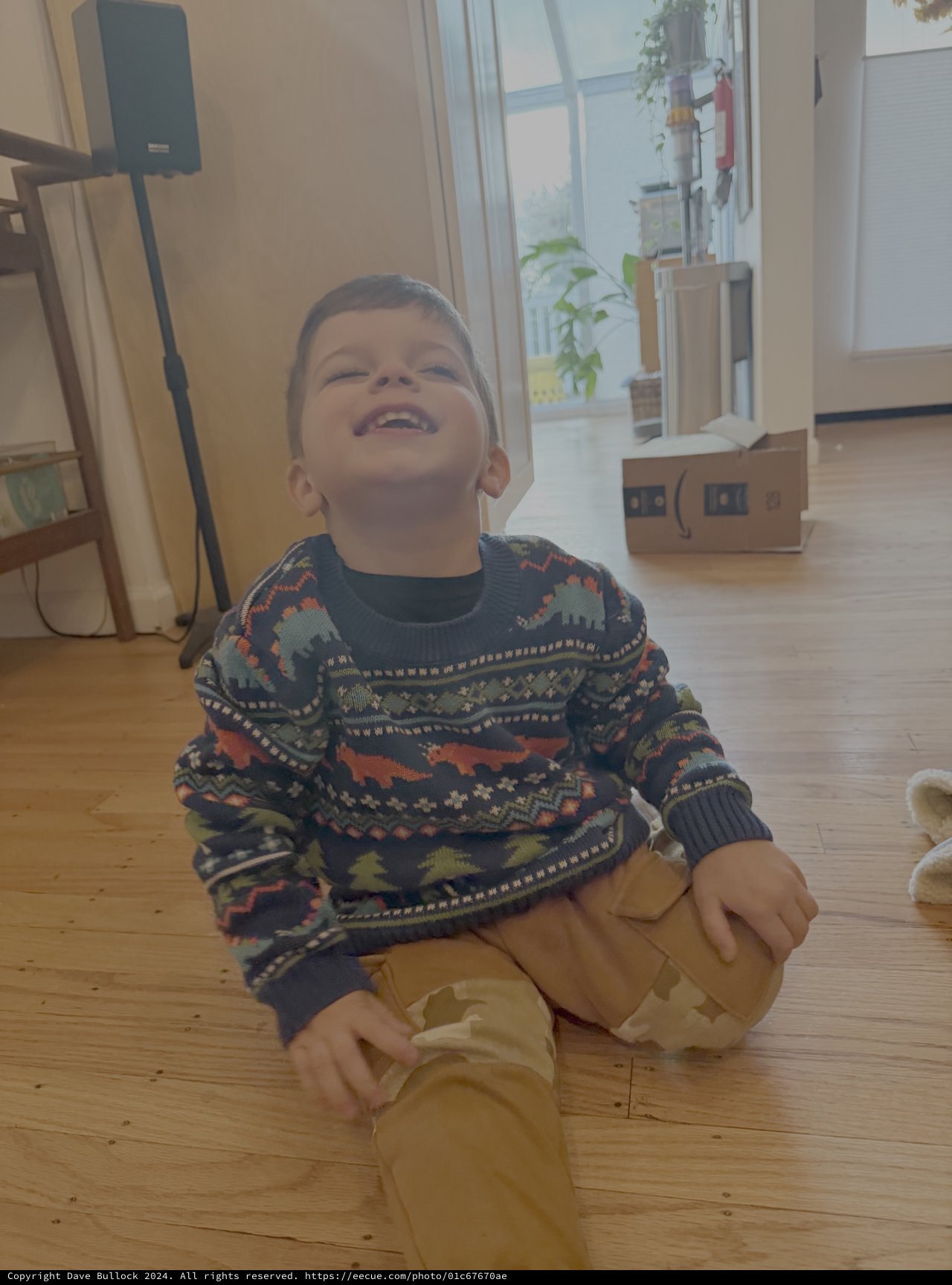 Joyful Child Laughing in Cozy Home Setting