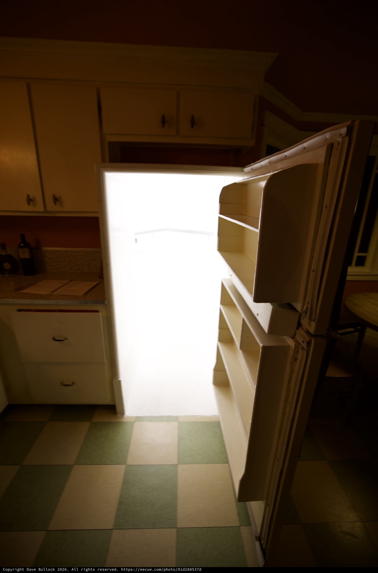 Bright Light Spilling from Open Refrigerator in Kitchen