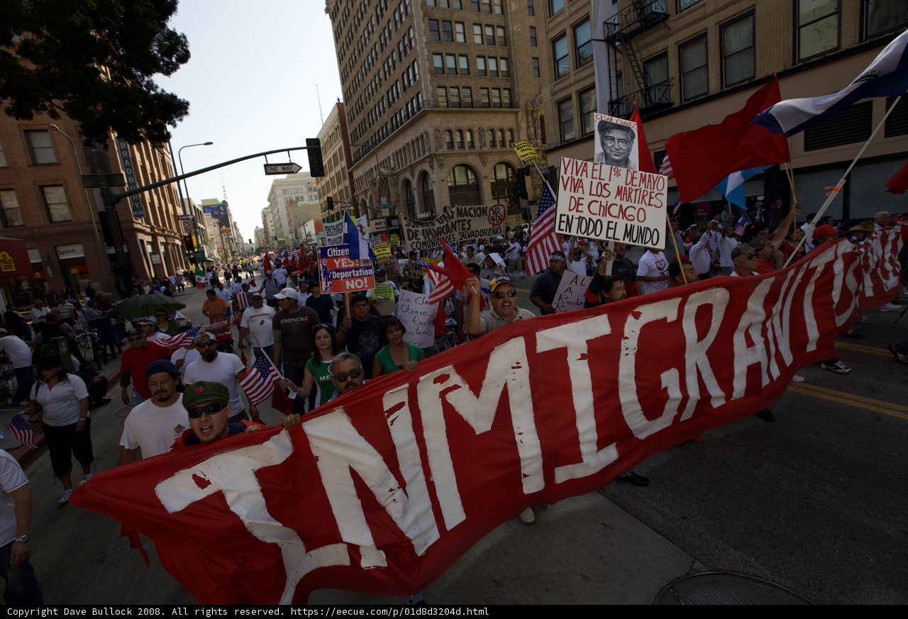 Immigrants stand united under a banner