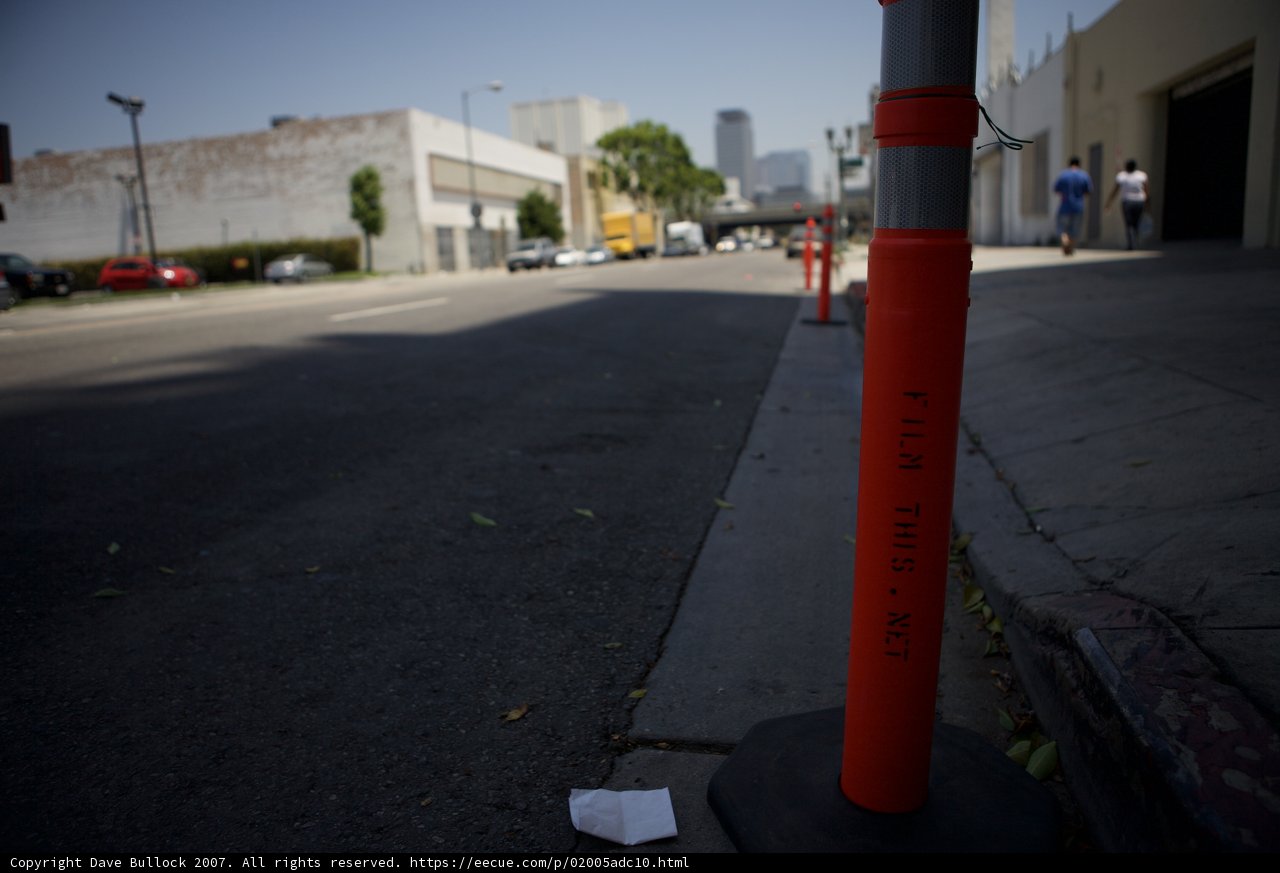 City Street Littered with Traffic Cone and Paper Bag