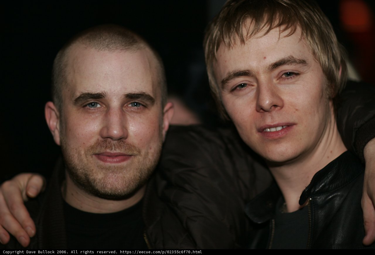 Two Men in Jackets Strike a Pose