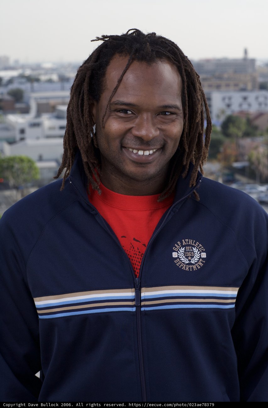 Outdoor Portrait of a Happy Man with Dreadlocks