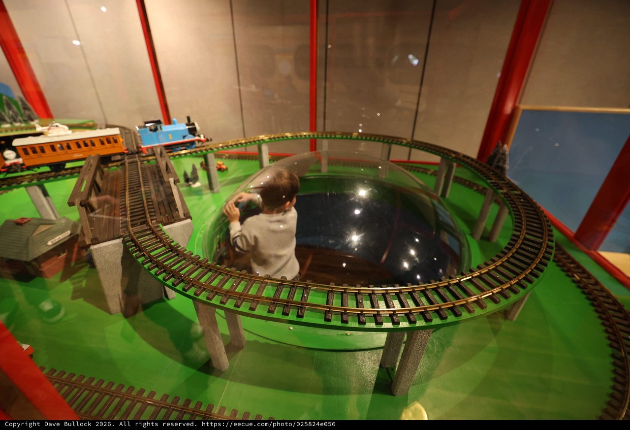 Child Operating Model Train Set at Interactive Museum Display