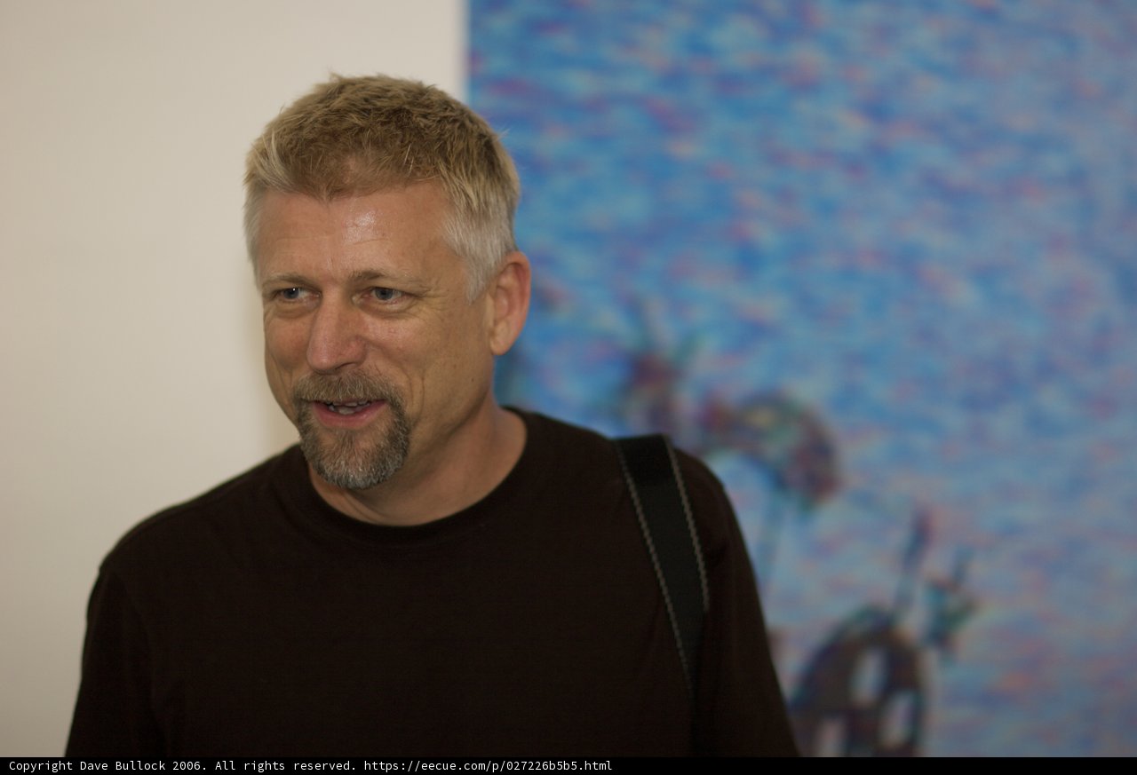 Smiling Man in Front of Painting