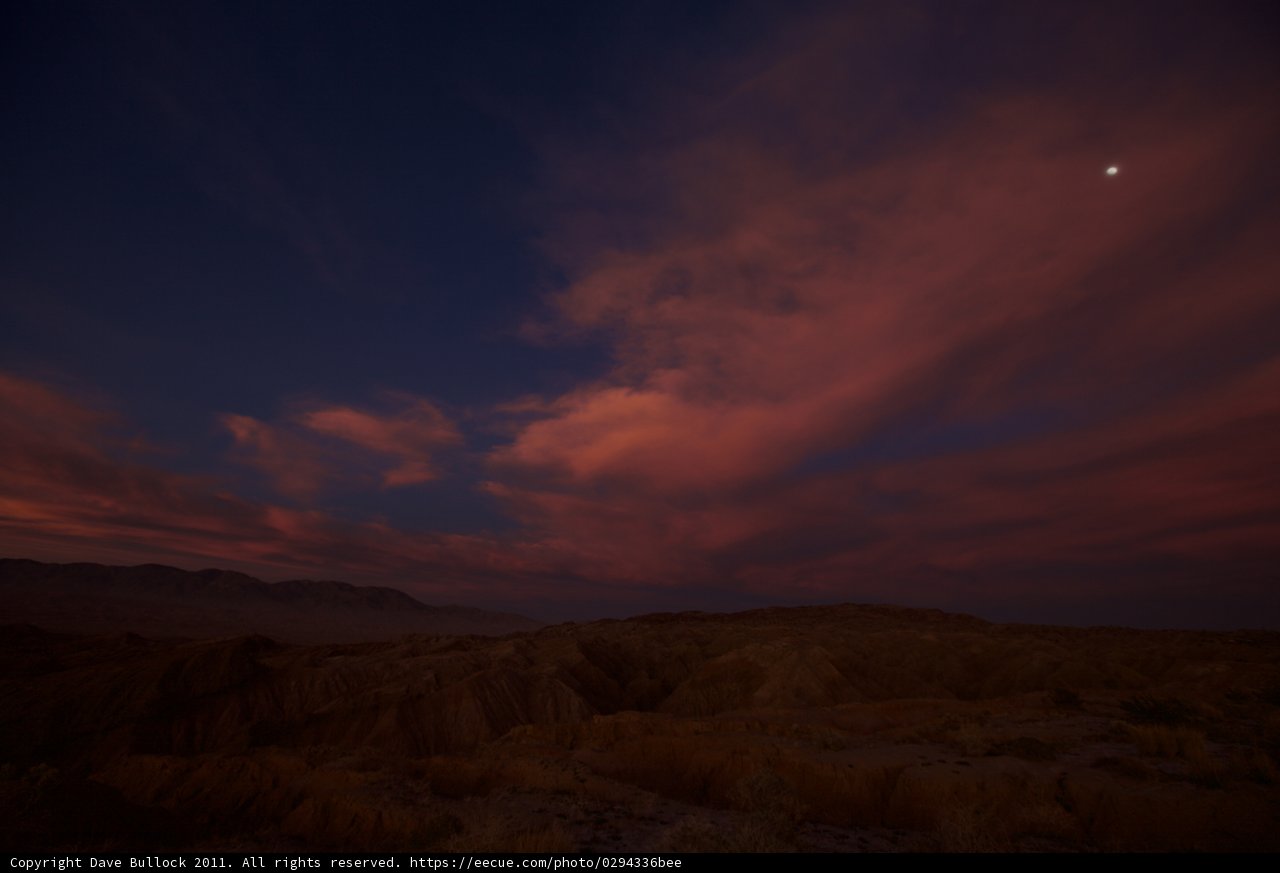 Moon and Clouds Dance at Sunset