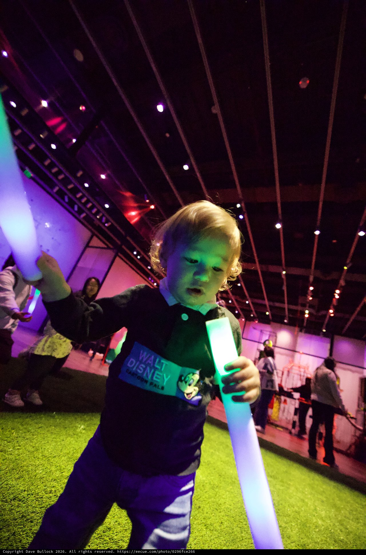 Young Child with Light Saber at Baby Rave Event