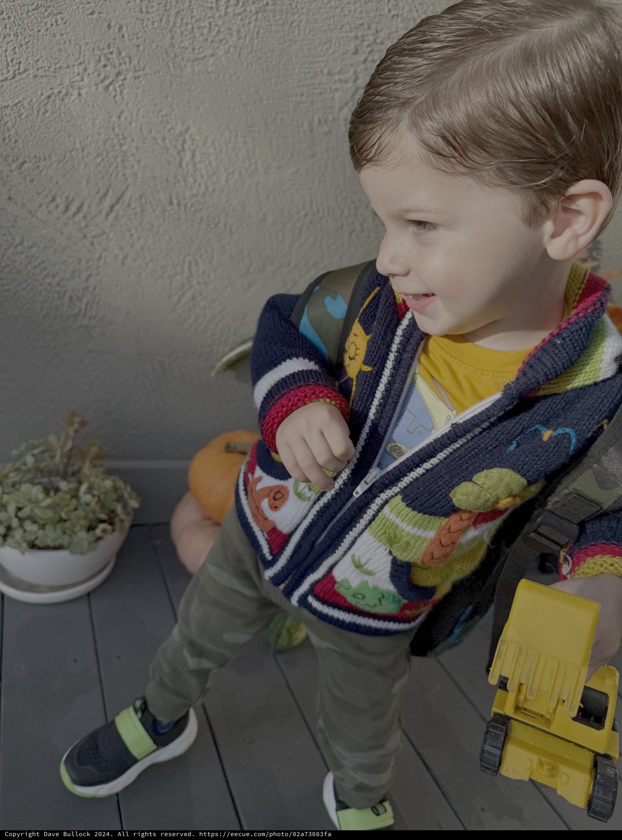 Toddler Playing with Yellow Toy Truck Outdoors