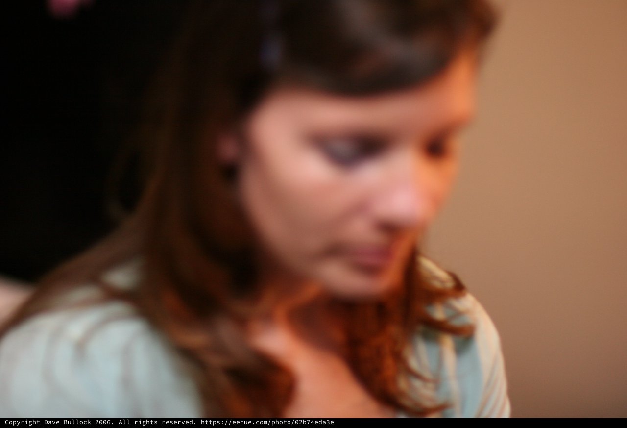 Contemplative Young Woman in Warm Indoor Light