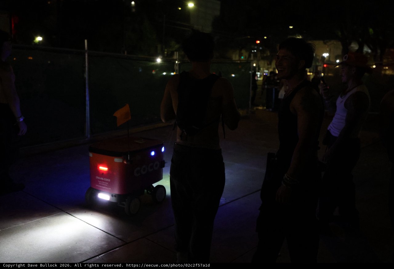 Coco Delivery Robot Encounters Festival Goers at Night
