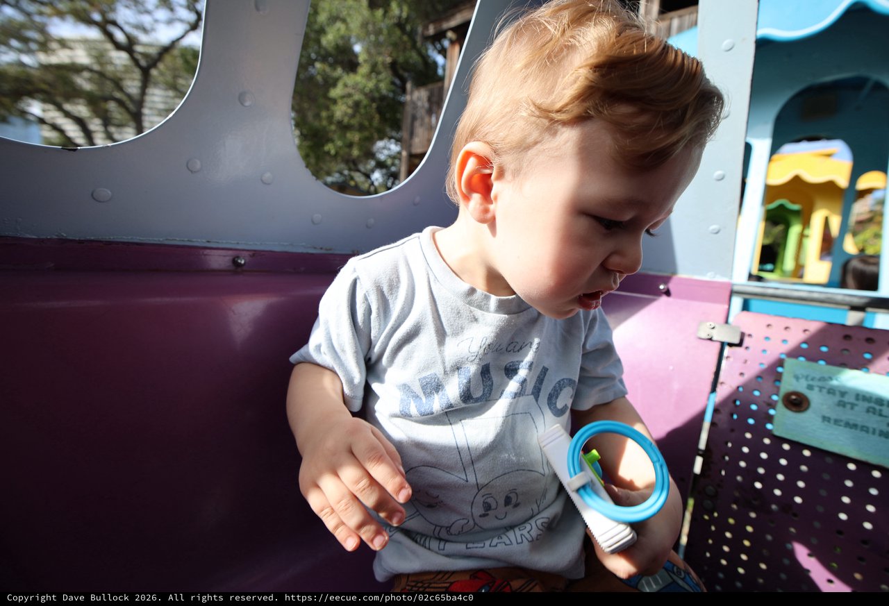 Young Child Playing at Colorful Playground Equipment