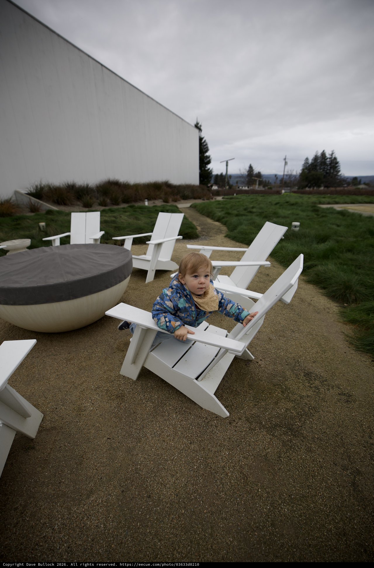 Toddler Relaxing in Adirondack Chair on Cloudy Day