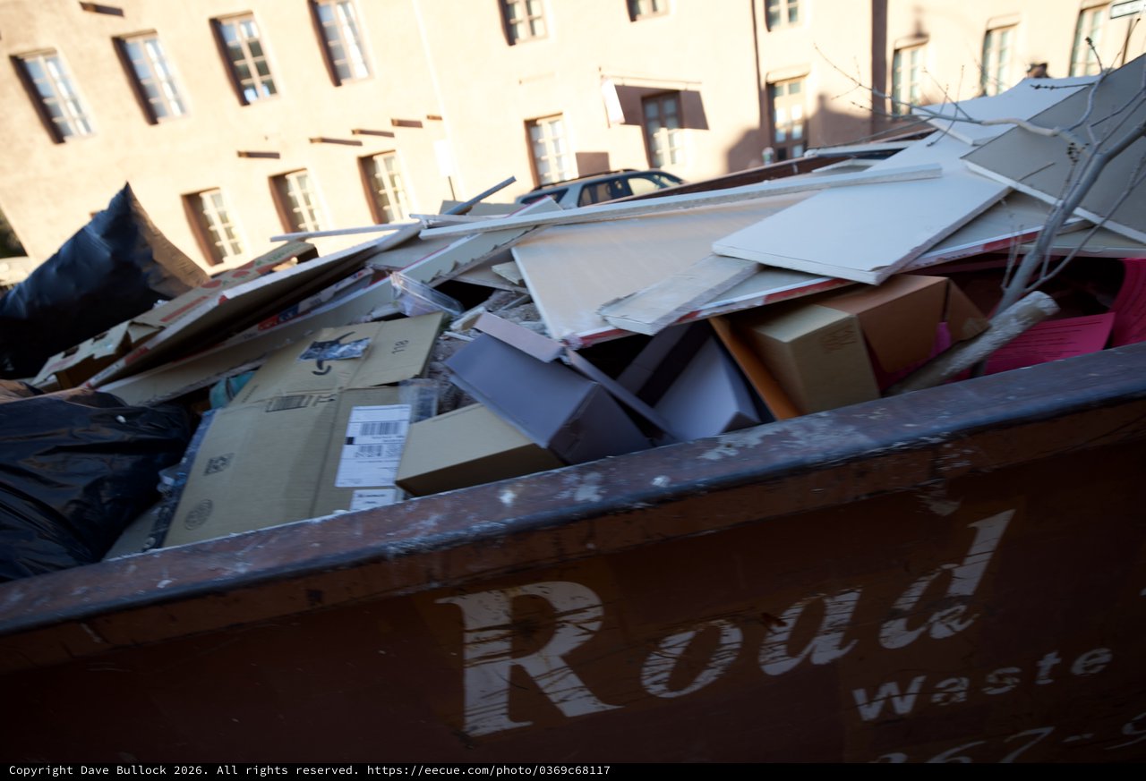 Overflowing Recycling Dumpster in Historic Urban Setting