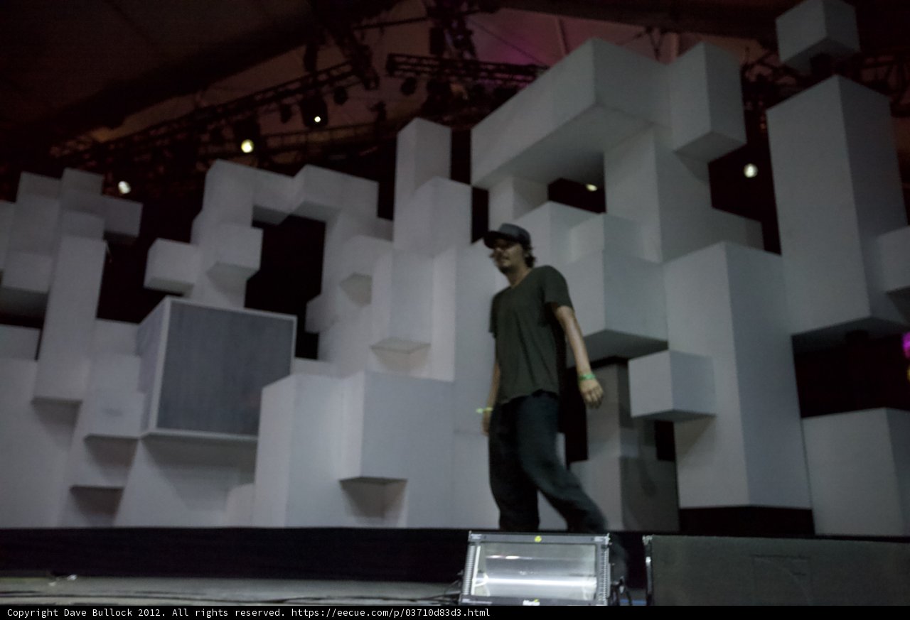 Man on Stage with Cube Backdrop