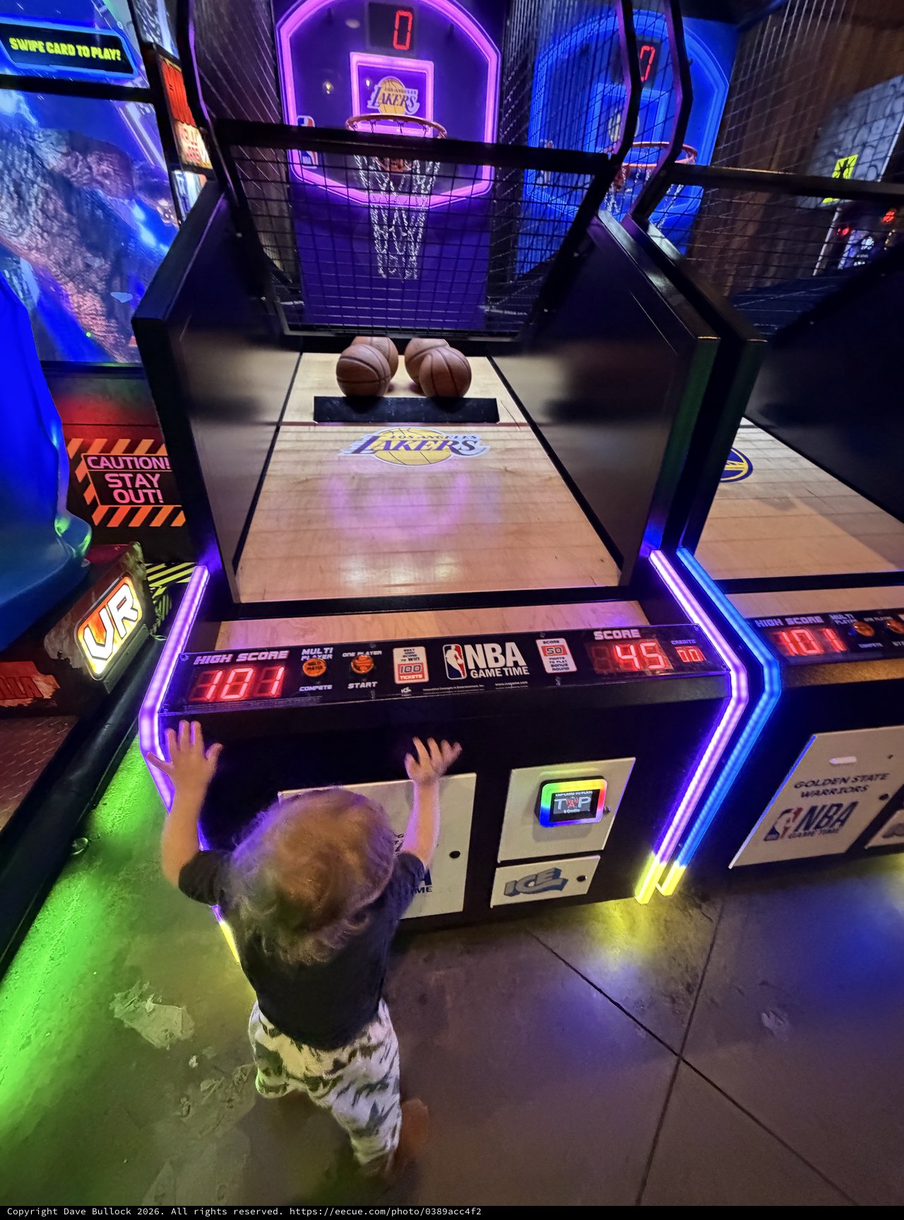 Young Child Playing NBA Basketball Arcade Game