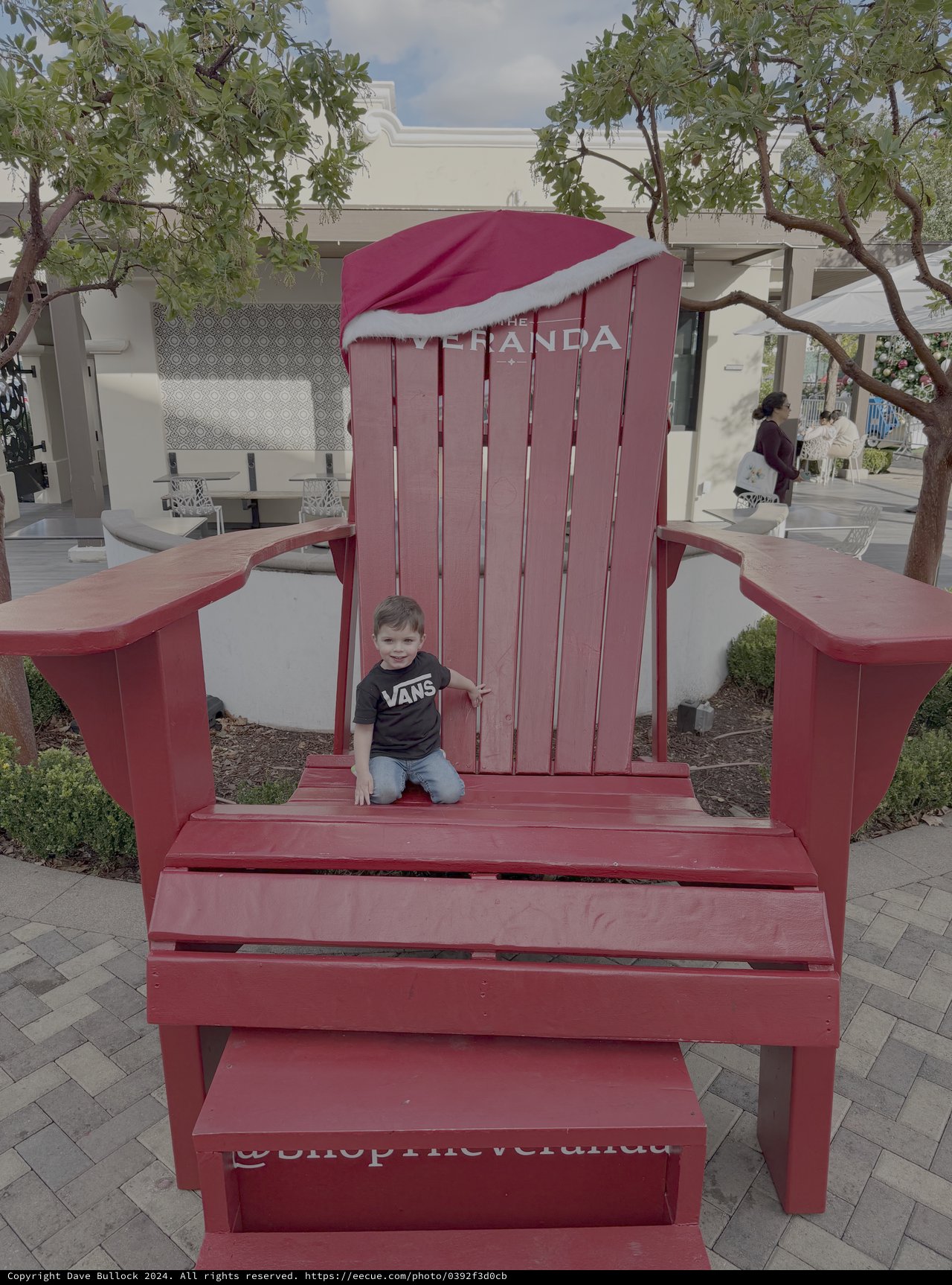 Child Playing in Giant Red Adirondack Chair