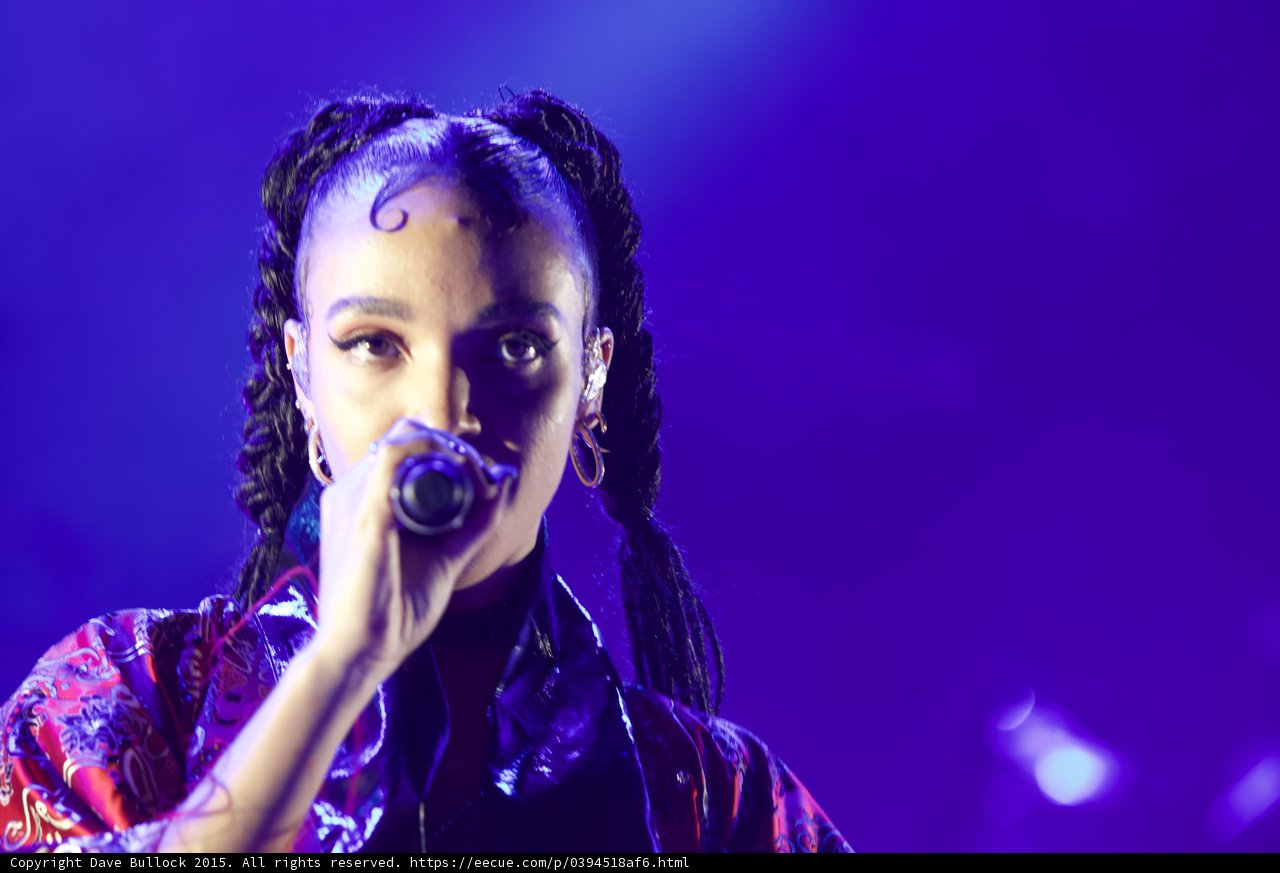 FKA twigs Intimate Portrait Face Visible Baby Hairs Swirls Cat-Eye Makeup Hoop Earrings Braided Ponytails Framing Face Rings Kimono Red Gold Patterns Purple Blue Lighting Spotlight