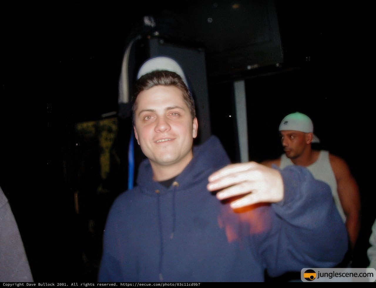 Man in Hoodie Enjoying His Drink