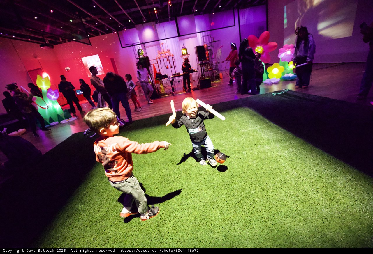 Children Playing with Light Sticks at Baby Rave Event