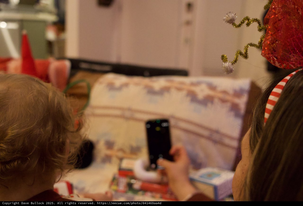 Children Capturing Christmas Morning Memories with Phone