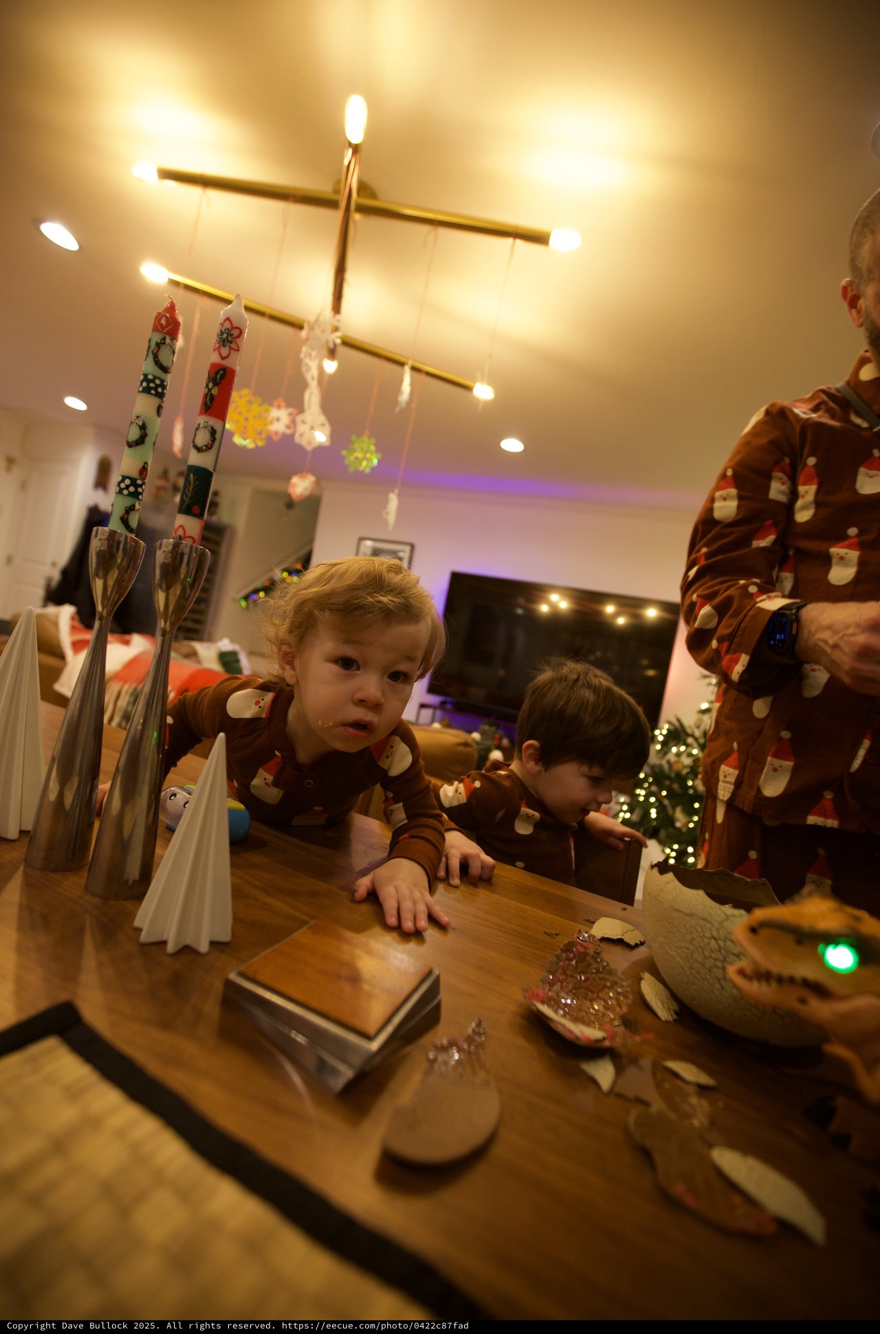 Children in Festive Pajamas at Christmas Table