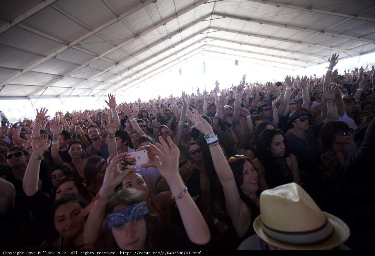 Crowd Goes Wild Caption: Excitement rises as festival-goers raise their hands in the air to the beat of the music at the 2012 Coachella music festival. Caroline de Maigret, Scott Russell, Tyson Heung, and Pier Silvio Berlusconi (pictured) join in the fun with their stylish hats and accessories.
