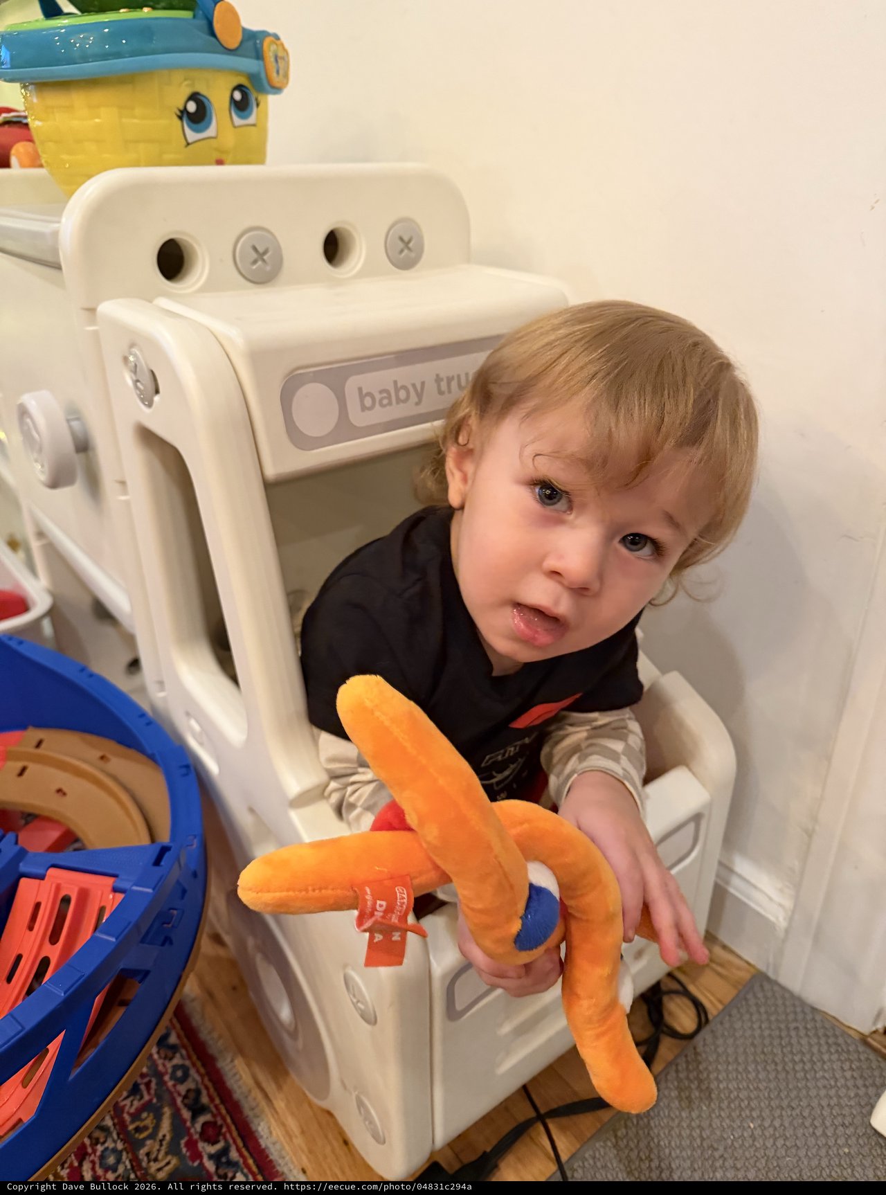 Toddler Playing in White Toy Truck