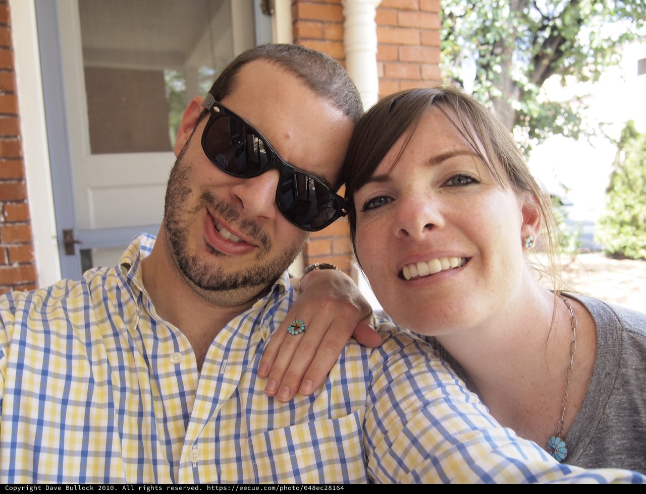Smiling Couple Poses Together on Sunny Porch