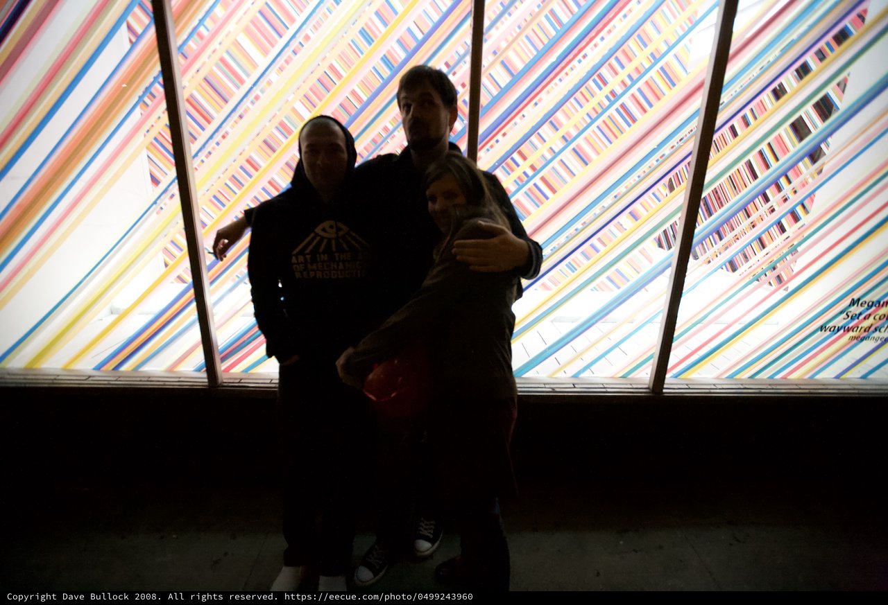 Silhouettes Against Colorful Striped Art Installation