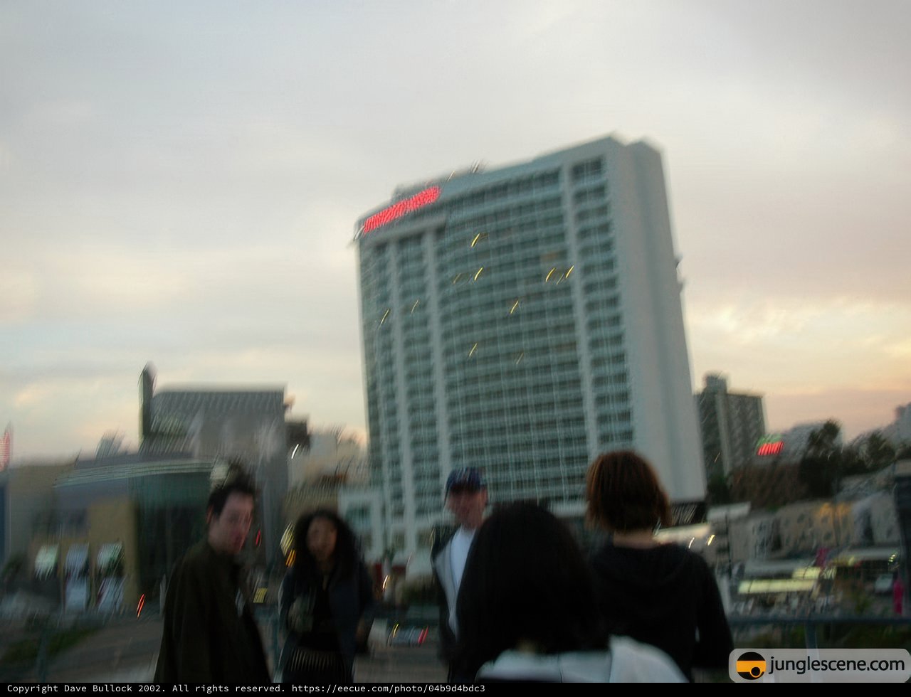 City Dwellers in Front of a High Rise