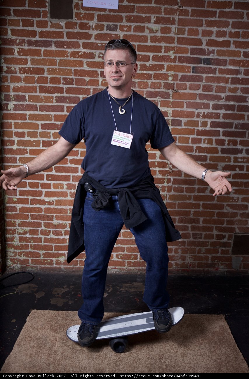 Skater Boy Poses by Brick Wall