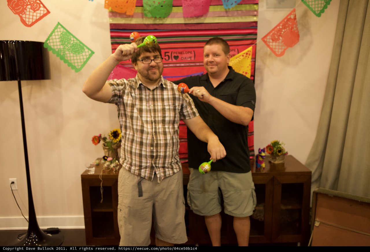 Two Friends Celebrate with Maracas at Fiesta Party
