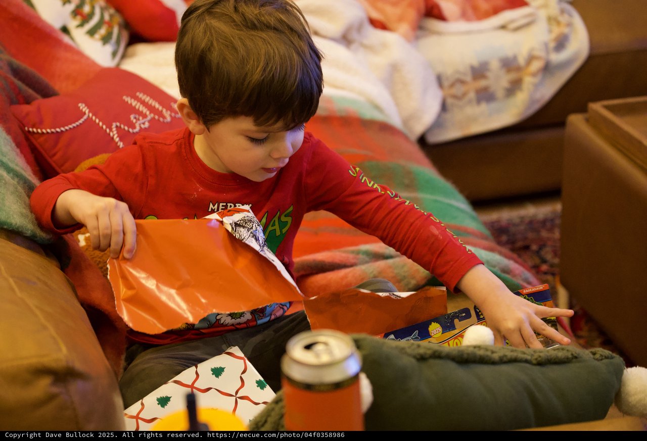 Young Boy Unwrapping Christmas Presents on Christmas Morning