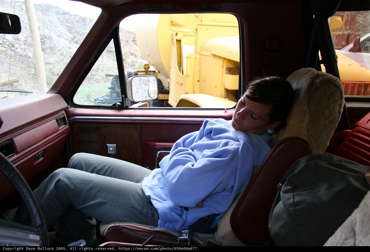 Weary Traveler Napping in a Vintage Truck Cab