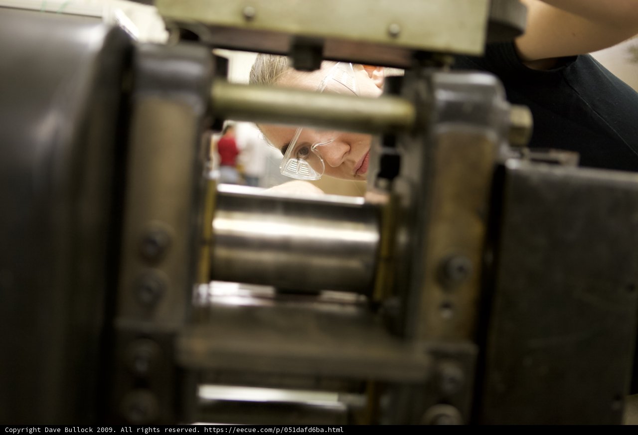 Woman Operating a Metal Lathe in a Factory