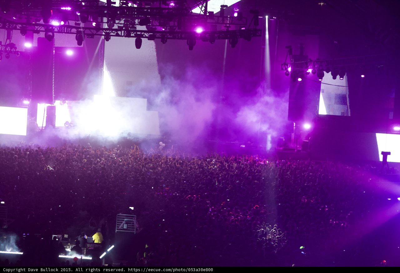Purple Spotlight on the Rock Concert Crowd