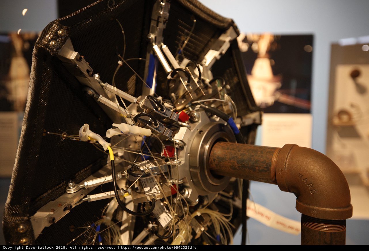 Vintage Aircraft Engine with Curved Exhaust Pipe Display